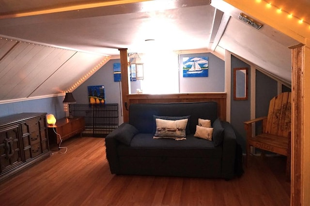 additional living space with hardwood / wood-style flooring and lofted ceiling