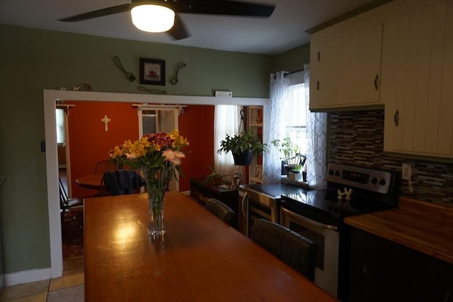 dining room featuring light tile patterned floors and ceiling fan