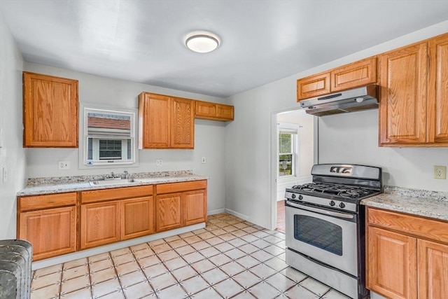 127-129 Blue Hills Pkwy, Milton, MA 02186 - kitchen with stainless steel range with gas cooktop, under cabinet range hood, and brown cabinetry