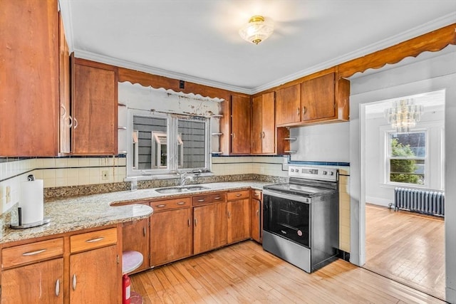 127-129 Blue Hills Pkwy, Milton, MA 02186 - kitchen featuring stainless steel range with electric cooktop, radiator, brown cabinetry, light wood-style floors, and tasteful backsplash