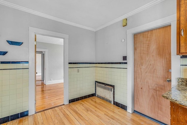 127-129 Blue Hills Pkwy, Milton, MA 02186 - unfurnished living room featuring tile walls, hardwood / wood-style flooring, ornamental molding, radiator, and wainscoting