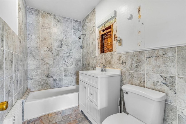 127-129 Blue Hills Pkwy, Milton, MA 02186 - bathroom featuring tile walls,  shower combination, vanity, stone finish floors, and radiator heating unit