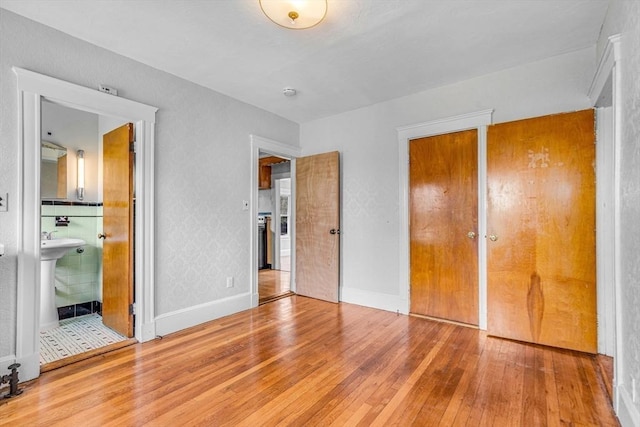 127-129 Blue Hills Pkwy, Milton, MA 02186 - unfurnished bedroom featuring hardwood / wood-style floors and baseboards
