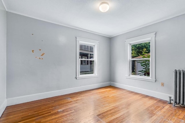 127-129 Blue Hills Pkwy, Milton, MA 02186 - spare room with radiator, hardwood / wood-style flooring, and crown molding