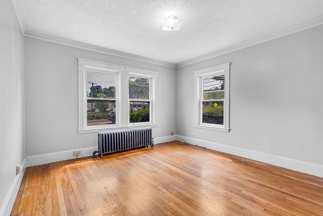 127-129 Blue Hills Pkwy, Milton, MA 02186 - empty room with radiator, light wood-style flooring, a textured ceiling, and crown molding