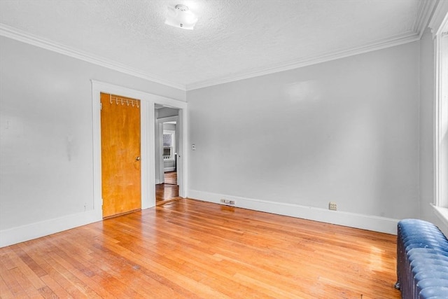127-129 Blue Hills Pkwy, Milton, MA 02186 - spare room with radiator heating unit, hardwood / wood-style floors, a textured ceiling, and crown molding