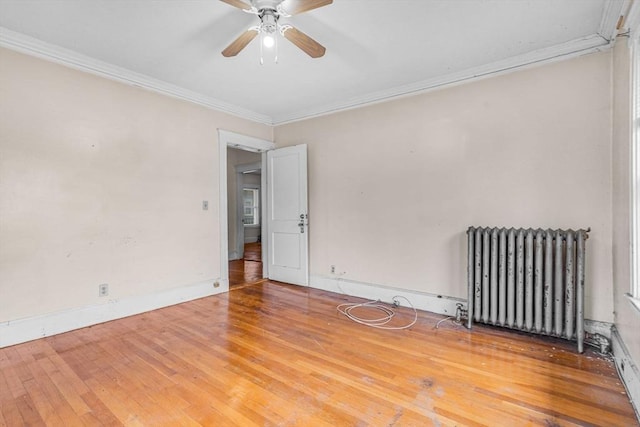 127-129 Blue Hills Pkwy, Milton, MA 02186 - empty room featuring radiator heating unit, wood-type flooring, crown molding, and ceiling fan