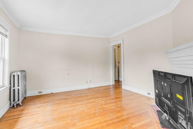 127-129 Blue Hills Pkwy, Milton, MA 02186 - unfurnished living room with radiator, light wood-style floors, and ornamental molding
