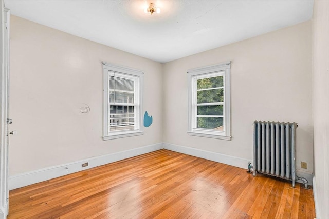 127-129 Blue Hills Pkwy, Milton, MA 02186 - empty room featuring radiator heating unit and light wood finished floors