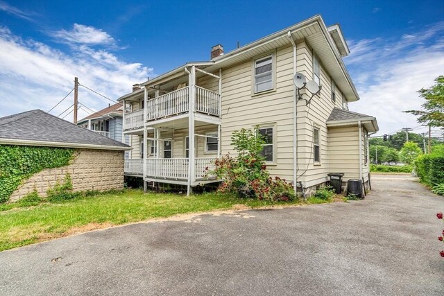 127-129 Blue Hills Pkwy, Milton, MA 02186 - rear view of house with a chimney and a balcony