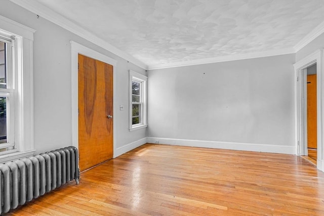 127-129 Blue Hills Pkwy, Milton, MA 02186 - empty room featuring radiator heating unit, light wood finished floors, and crown molding