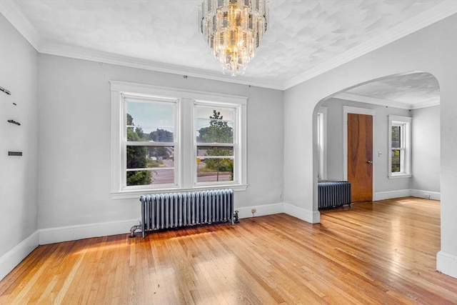 127-129 Blue Hills Pkwy, Milton, MA 02186 - unfurnished room with radiator, arched walkways, light wood-style floors, a chandelier, and crown molding