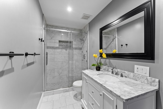 bathroom with toilet, a shower with door, vanity, and tile patterned flooring