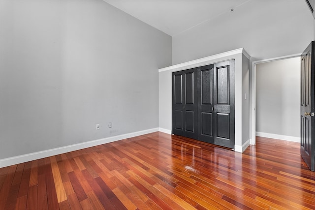 unfurnished bedroom featuring hardwood / wood-style flooring and a closet