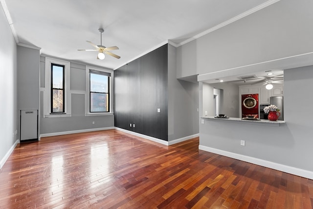 empty room featuring hardwood / wood-style flooring, ceiling fan, and ornamental molding