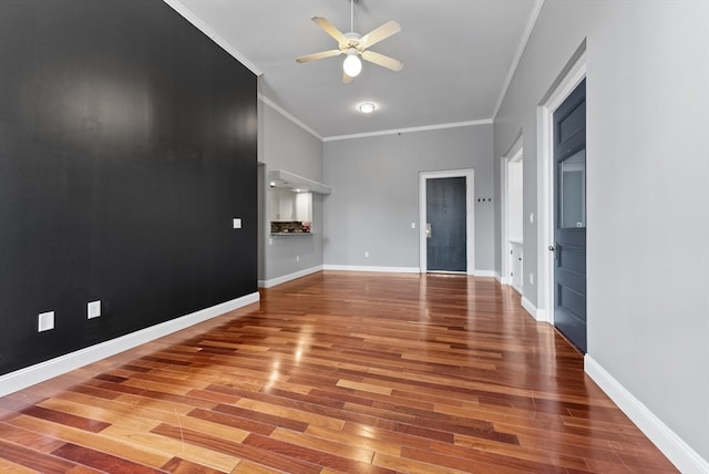 unfurnished living room featuring ceiling fan, wood-type flooring, and crown molding