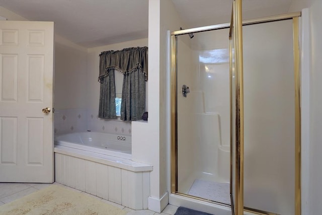 bathroom featuring a shower stall, tile patterned flooring, and a whirlpool tub