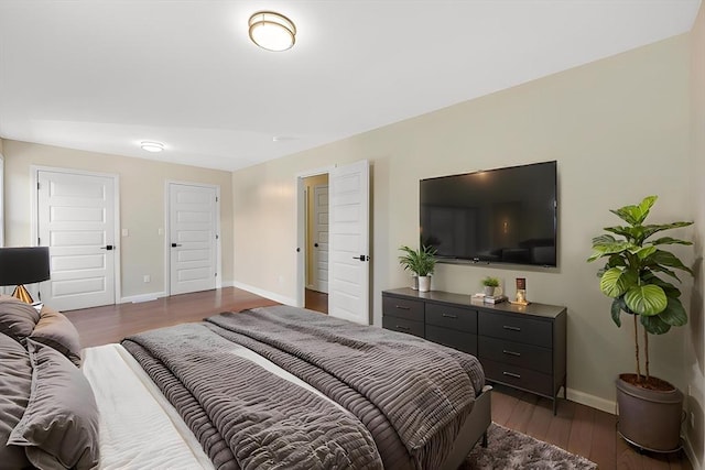 bedroom with baseboards and dark wood-style floors