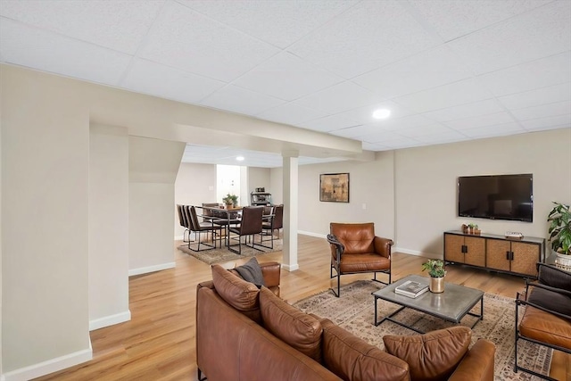 living area featuring baseboards and light wood-style floors