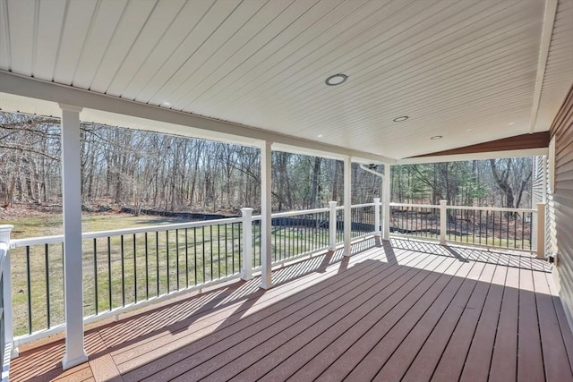 wooden terrace with a lawn