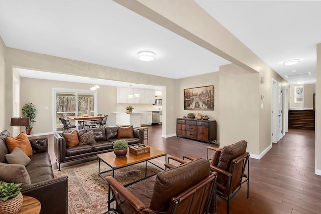 living area with stairway, wood finished floors, and baseboards