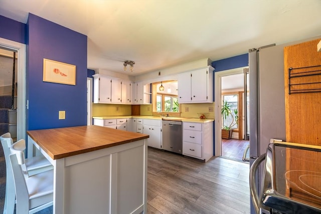 203 State St, Northampton, MA 01060 - kitchen with stainless steel dishwasher, dark wood-style floors, white cabinetry, and wooden counters