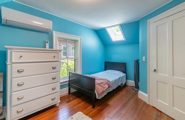 203 State St, Northampton, MA 01060 - bedroom featuring a skylight, an AC wall unit, hardwood / wood-style flooring, vaulted ceiling, and baseboards