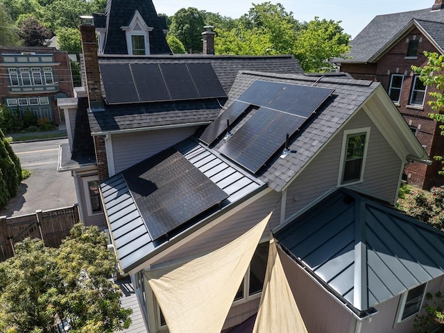 203 State St, Northampton, MA 01060 - view of property exterior with a chimney, roof with shingles, and solar panels