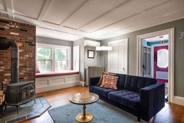 203 State St, Northampton, MA 01060 - living area with radiator heating unit, a wood stove, light wood-style flooring, and baseboards