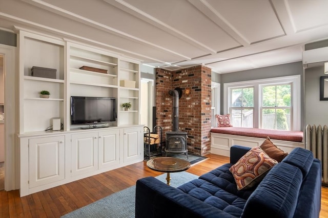 203 State St, Northampton, MA 01060 - living area featuring hardwood / wood-style flooring, a wood stove, and radiator
