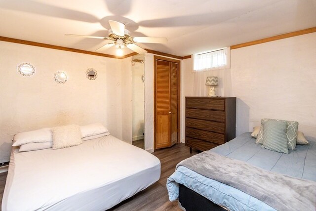 bedroom featuring a closet, ceiling fan, dark hardwood / wood-style flooring, and ornamental molding