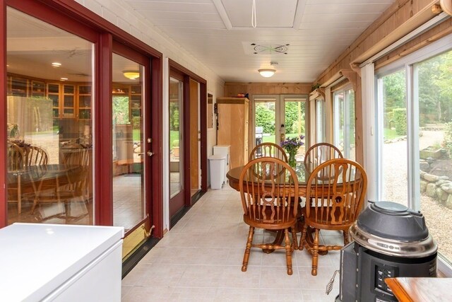 sunroom / solarium featuring french doors