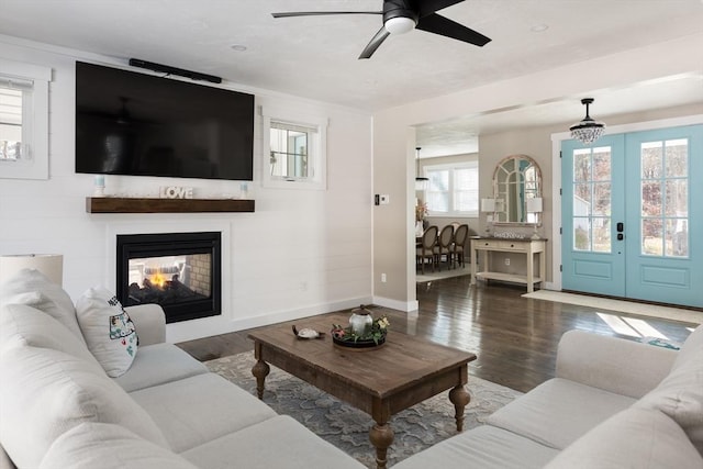 79 Neshobe Rd, Mashpee, MA 02649 - living area with wood finished floors, ceiling fan, and a multi sided fireplace
