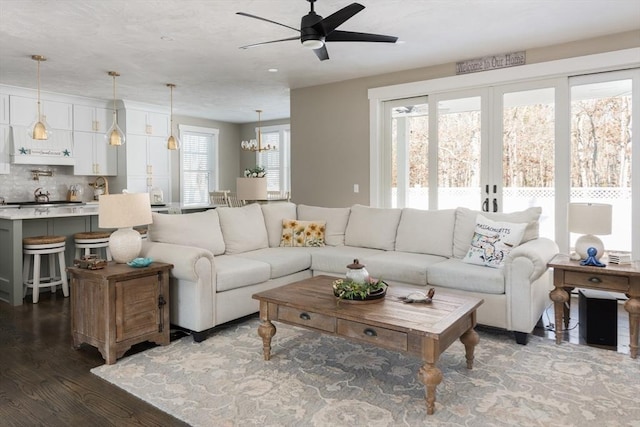 79 Neshobe Rd, Mashpee, MA 02649 - living room featuring dark wood-style flooring, ceiling fan, and a chandelier