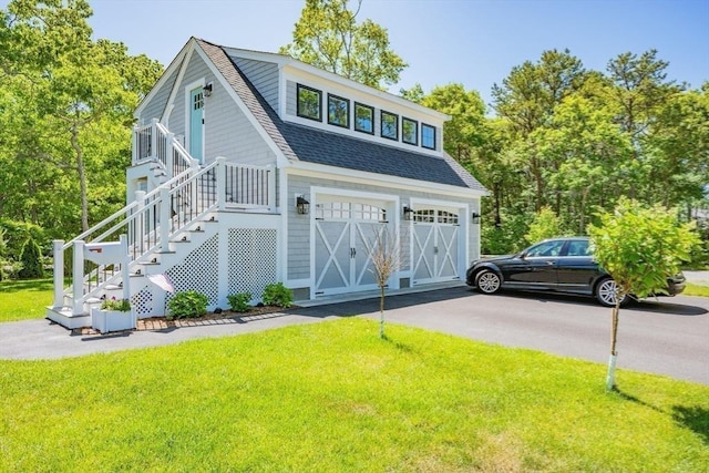 79 Neshobe Rd, Mashpee, MA 02649 - view of front of house featuring a shingled roof, a front lawn, driveway, and a garage