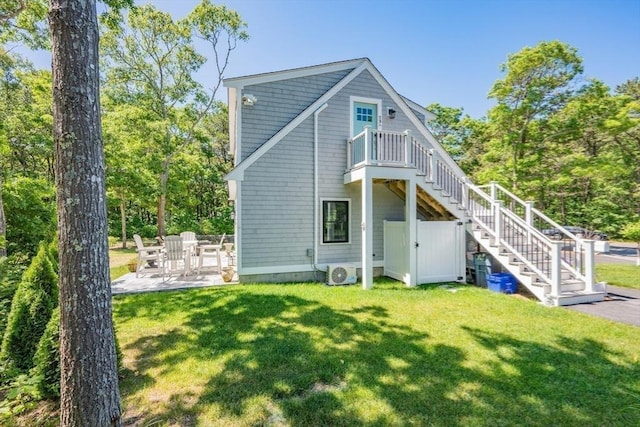 79 Neshobe Rd, Mashpee, MA 02649 - back of property with stairs, a patio, and a lawn