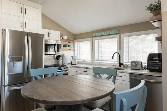 79 Neshobe Rd, Mashpee, MA 02649 - kitchen with stainless steel appliances, white cabinets, backsplash, vaulted ceiling, and open shelves