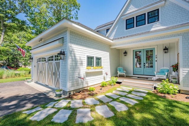 79 Neshobe Rd, Mashpee, MA 02649 - view of front of property with french doors, an attached garage, and a porch