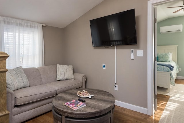 79 Neshobe Rd, Mashpee, MA 02649 - living room with vaulted ceiling, a wall mounted air conditioner, a ceiling fan, and wood finished floors