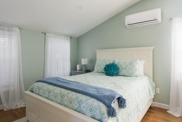 79 Neshobe Rd, Mashpee, MA 02649 - bedroom featuring a wall unit AC, lofted ceiling, and light wood-style floors