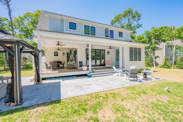79 Neshobe Rd, Mashpee, MA 02649 - back of house featuring a ceiling fan, board and batten siding, outdoor lounge area, and a gazebo