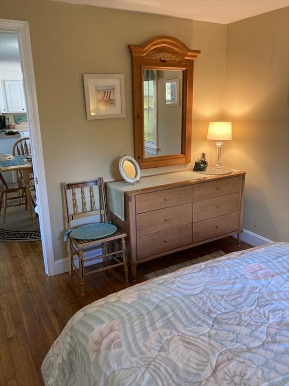 bedroom with dark hardwood / wood-style floors