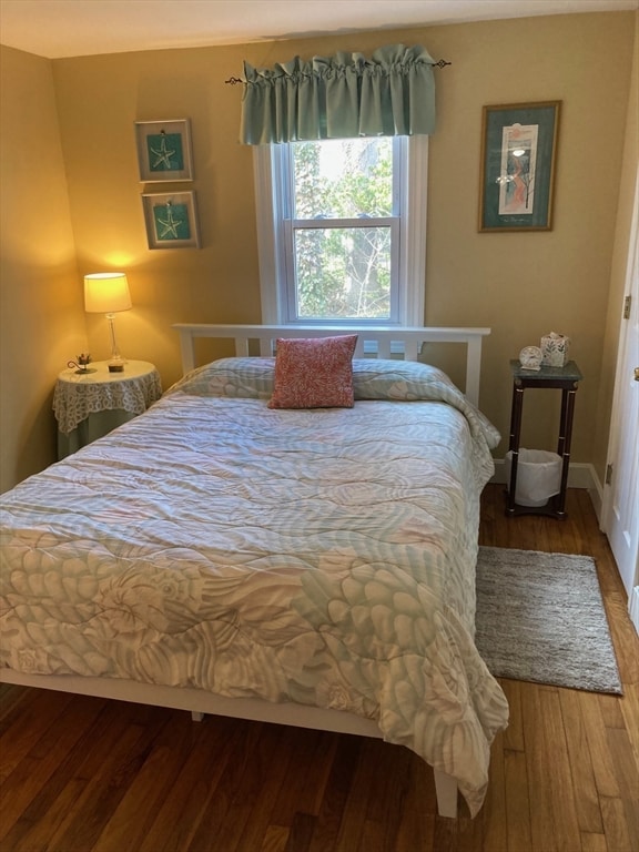 bedroom with hardwood / wood-style flooring