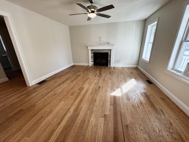 unfurnished living room featuring ceiling fan and light hardwood / wood-style flooring