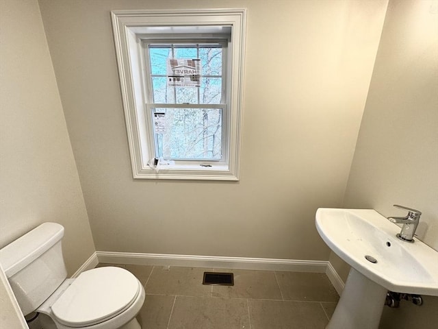 bathroom with tile patterned floors, toilet, and sink