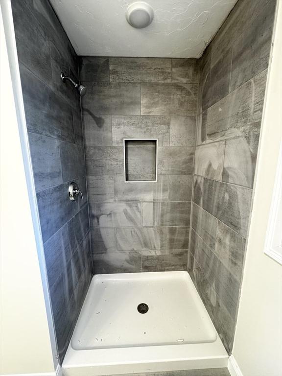 bathroom with a tile shower