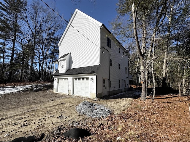 view of side of home featuring a garage