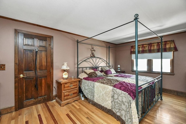 bedroom with crown molding and wood-type flooring