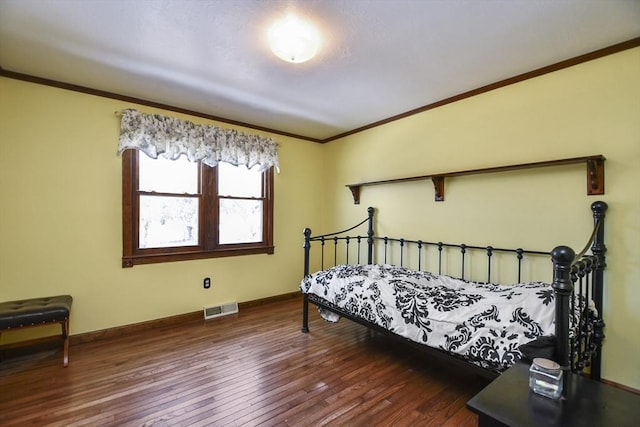 bedroom featuring ornamental molding and dark wood-type flooring