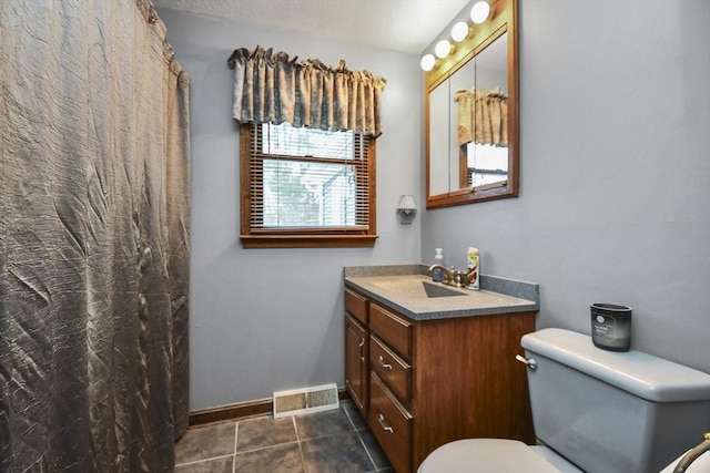 bathroom featuring a shower with curtain, vanity, toilet, and tile patterned flooring